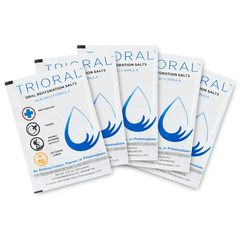 Five TRIORAL Oral Rehydration Salts packets from the 15-pack box are arranged in a fan, showing white packets with blue accents, a water droplet graphic, and text highlighting their effective electrolyte rehydration benefits.