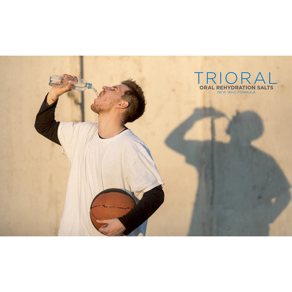 A man holding a basketball drinks water outdoors, casting a shadow on the wall. “TRIORAL Natural Lemon w/ Stevia Oral Rehydration Salts (WHO New Formula, 25 Packets/Box)” appears above, highlighting fast dehydration relief.