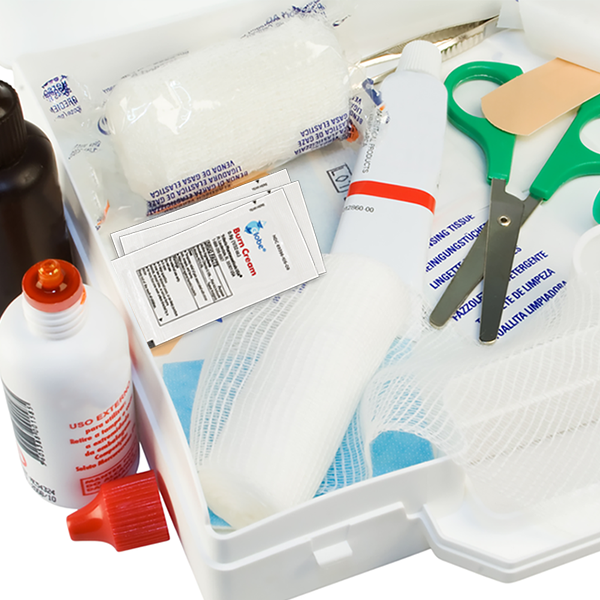 A close-up of an open first aid kit featuring Globe First Aid Burn Cream 0.9g packets (Box of 144) by Globe, along with bandages, gauze, scissors, adhesive bandages, ointment tubes, antiseptic wipes, and medicine bottles.