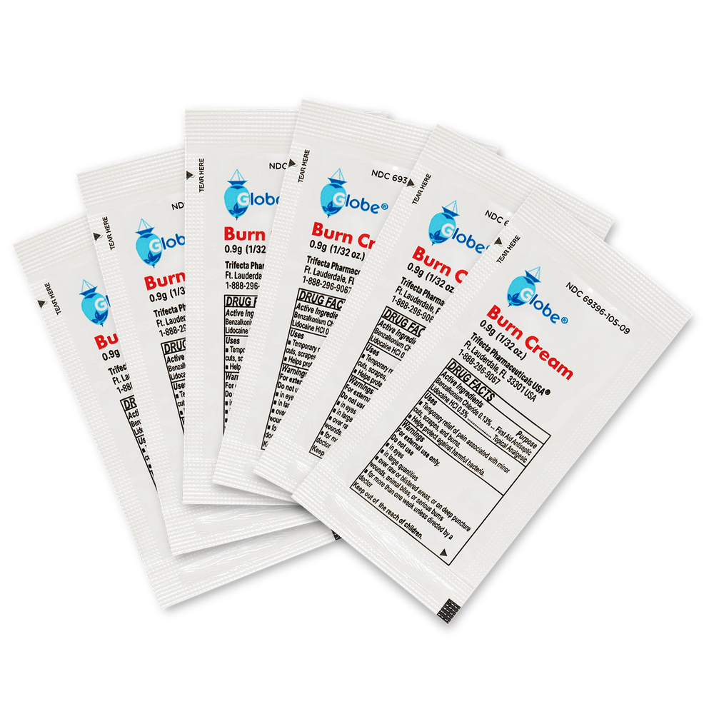 A box of 144 Globe First Aid Burn Cream 0.9g packets, each with blue and red text, provides temporary relief for minor burns, cuts, and scrapes—perfect for any first aid kit.