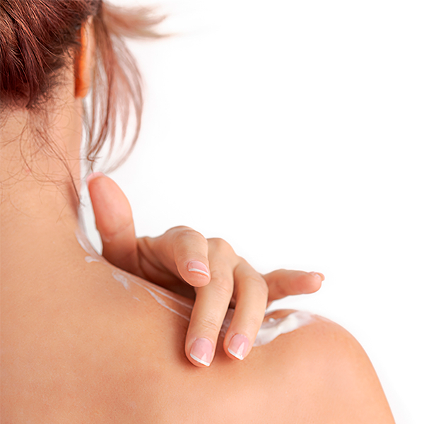 A person with light skin applies Globe Ultra Strength Greaseless Muscle Rub Cream (3 oz, 10% Menthol & 15% Methyl Salicylate) to their shoulder, shown from behind with only upper back, shoulder, neck, and hand visible against a plain white background.