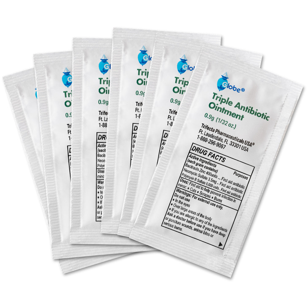 Five Globe Triple Antibiotic Ointment .9gr packets from a box of 144 are displayed fanned out, showing their white packaging with black text detailing dosage, ingredients, and drug facts for infection protection.
