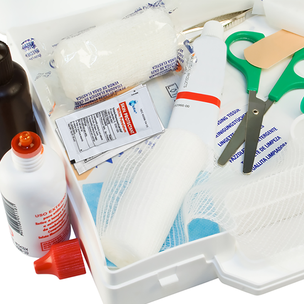 Open a first aid kit with Globe White Petrolatum packets for dry or cracked skin, bandages, scissors, gauze, antiseptic ointment, adhesive strips—all neatly organized in a white plastic box.